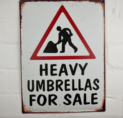 Heavy Umbrellas Tin Sign