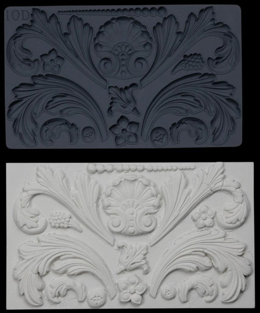 Iron Orchid Designs Acanthus Scroll Mould above white castings of the mould