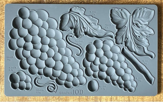 Iron Orchid Designs Grapes grey Mould laying on a wooden surface