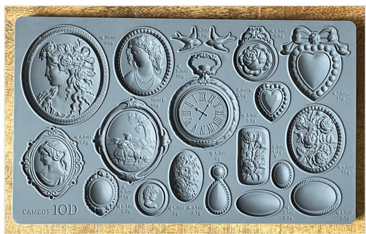 Iron Orchid Designs Cameos Mould. Grey mould laying on a wooden surface.